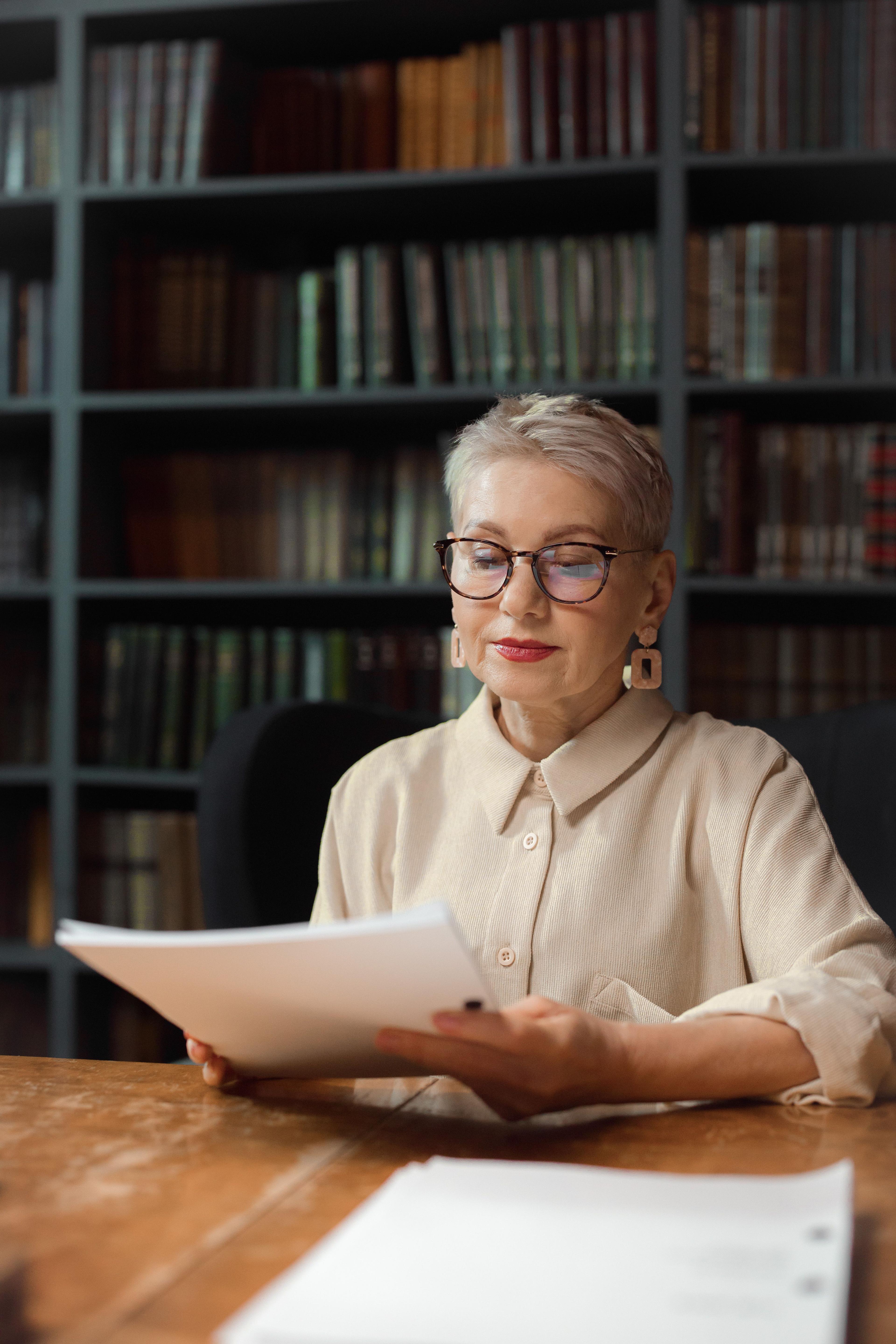 An executive preparing with written materials in a library