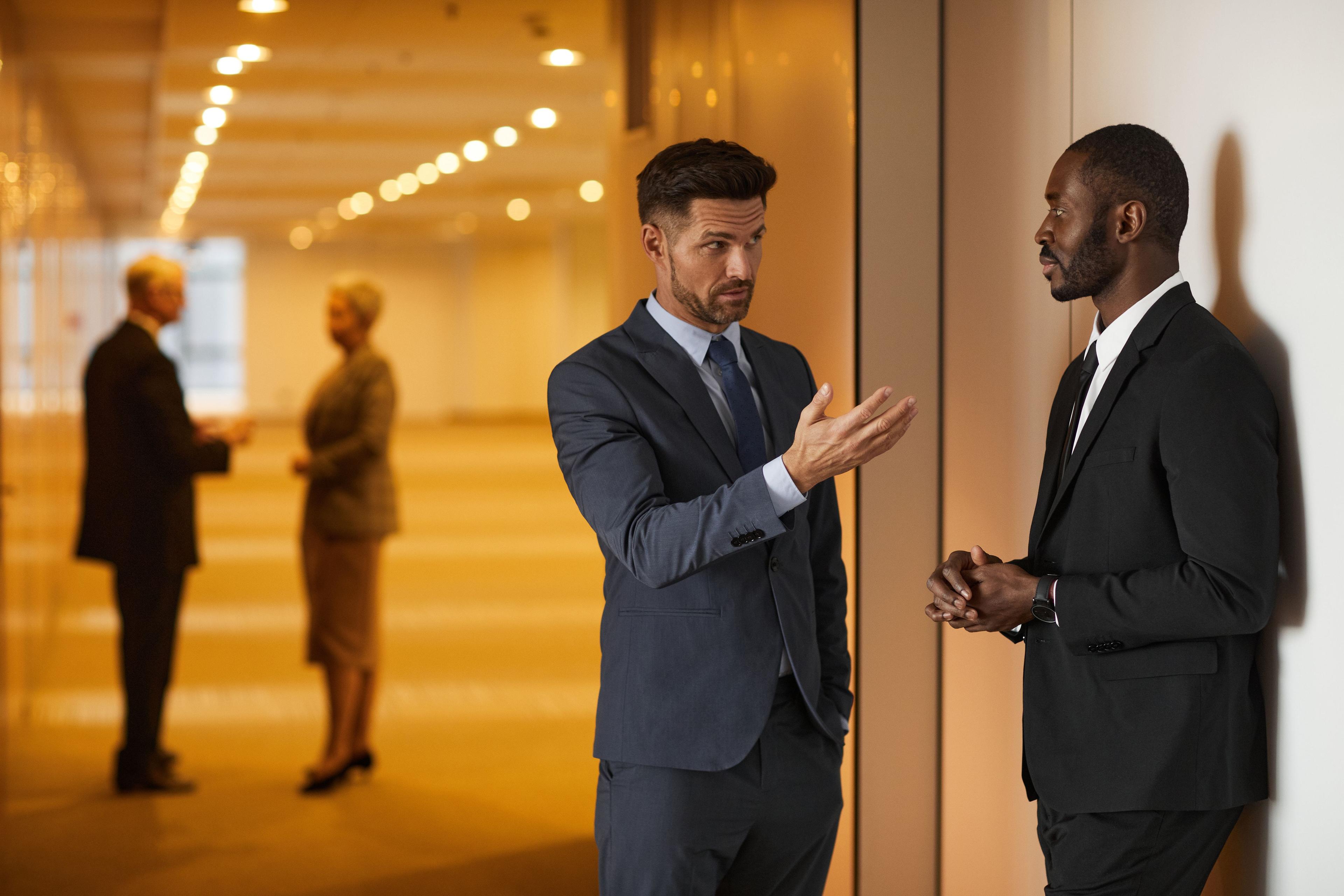 A discreet hallway conversation between search partners